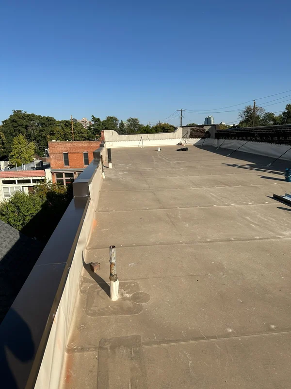 Flat commercial roof under a clear sky
