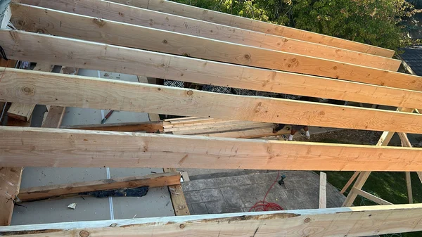 New lumber framing laid over a roof deck