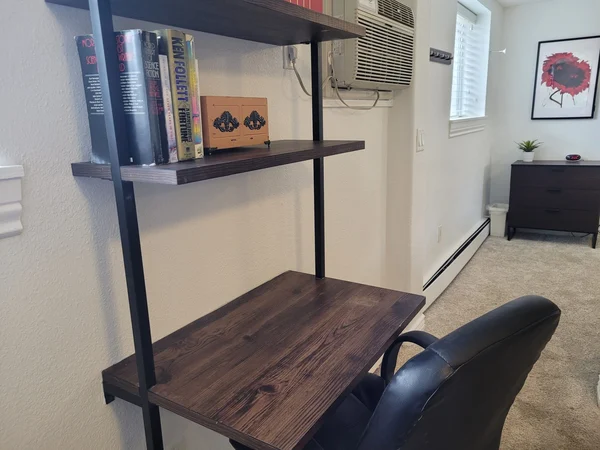 Tidy wall shelves and desk in a cleaned apartment
